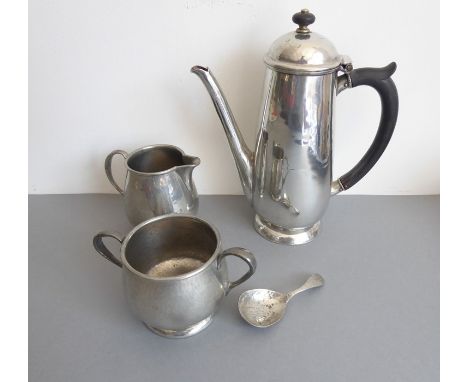 An early 20th century hand-planished polished pewter cream jug in Arts and Crafts style marked Tudric, Liberty &amp; Co, toge