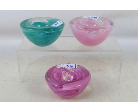 Three Kosta Boda glass bowls, largest 6.5 cm (h). [3]. [W]