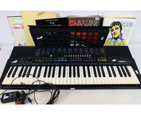 A Yamaha PSR-210 electronic keyboard and a quantity of music books. [2]. [W]