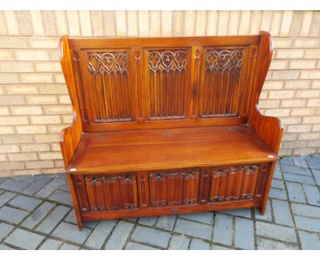A Monk's Bench, approx 105 cm (h) x 114 cm (w) x 45 cm (d)  (located at The Auction Centre, Runcorn)