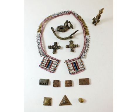 A group of Ashanti gold weights including Chieftain sitting on a stool, military cartridge belt, hornbill attacking snake, an