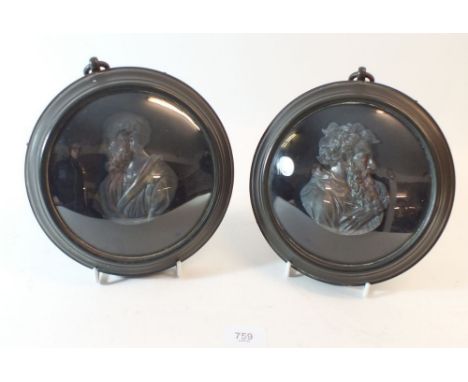 A pair of finely cast metal portrait busts of classical men with circular glazed ebonised frame - 19cm dia