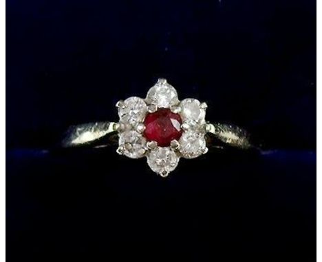 An 18 carat gold cluster ring set six diamonds and central ruby - size N 1/2