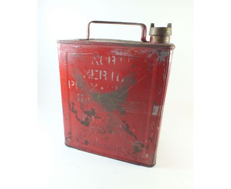 A vintage red petrol can marked 'SM &amp; BP'