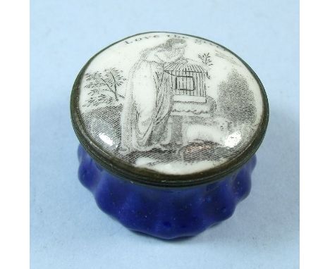 A late 18th century Bilston style circular enamel patch box decorated lady freeing a caged bird, with text 'Love the Giver'
