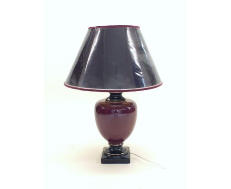 A large deep burgundy china table lamp and shade