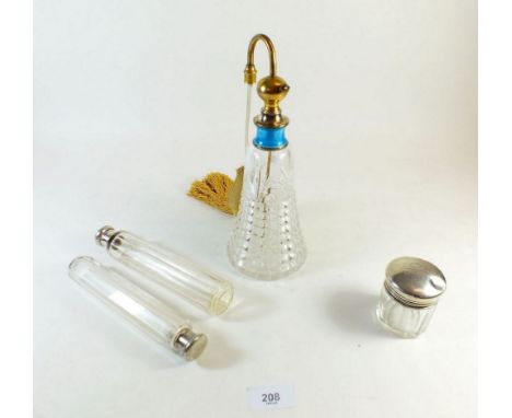 A large silver and enamel mounted cut glass perfume atomiser and three cut glass and silver mounted toiletry bottles