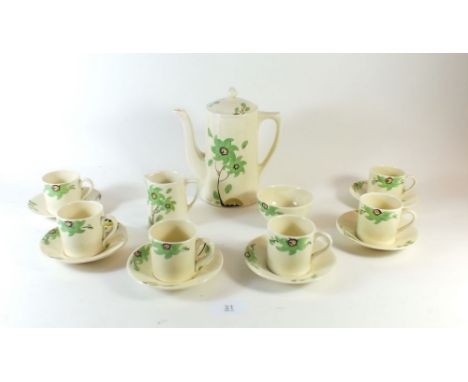 An Art Deco coffee set painted green flowers comprising: coffee pot, six cups and saucers, milk and sugar