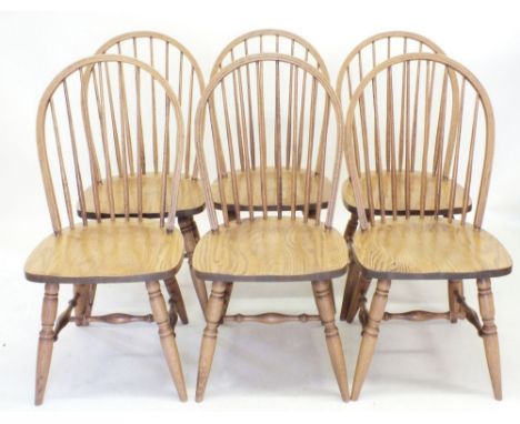 A set of six Canadian oak stick back dining chairs - 97cm tall