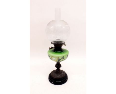 A Victorian copper and green glass oil lamp painted shamrock and harps with etched globe shade