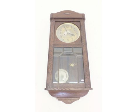 A 1930's glazed oak wall clock