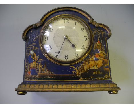 A painted wooden mantle clock with oriental decoration.