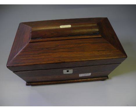 A rosewood sarcophagus shaped tea caddy on bun feet.