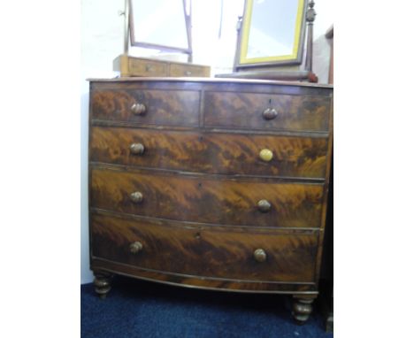 A Victorian mahogany bow fronted, two short, three long chest of drawers.