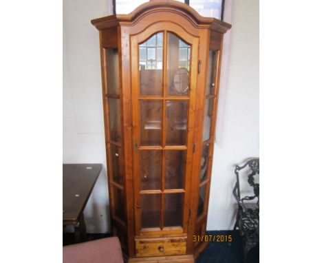A pine glazed single door shaped display unit with internal light.