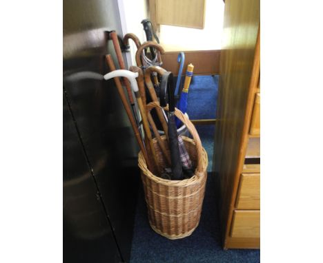 A quantity of walking sticks and blue and White ceramic umbrella stand.