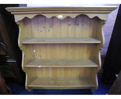 A pine wall mounted shelf unit.