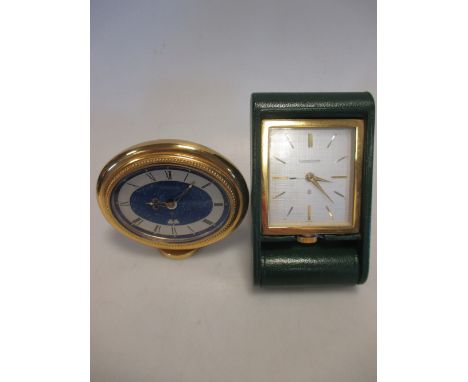 An oval Jaeger LeCoultre travel clock with lapis lazuli face and another green leather Jaeger LeCoultre travel clock (2)  
