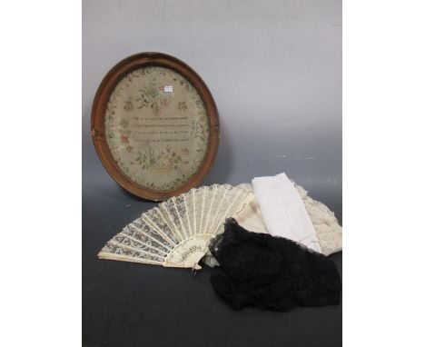 A Georgian oval needlework sampler, a quantity of linen including two unused Irish linen tablecloths, a feather quilt, lace w