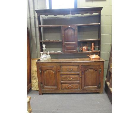 An 18th century oak Welsh dresser with raised open plate rack and spice cupboard, the base with drawers and cupboards, 152cm 