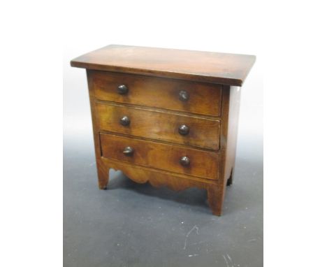 A George IV mahogany apprentice chest of drawers, on bracket feet together with a part 19th century ivory Chess set  