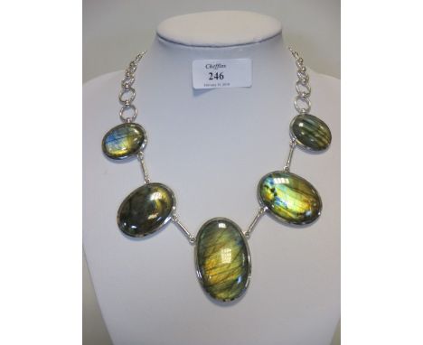 A labradorite necklace, the five oval cabochons in collet mounts, largest 5cm long, and interspaced with straight links, to a
