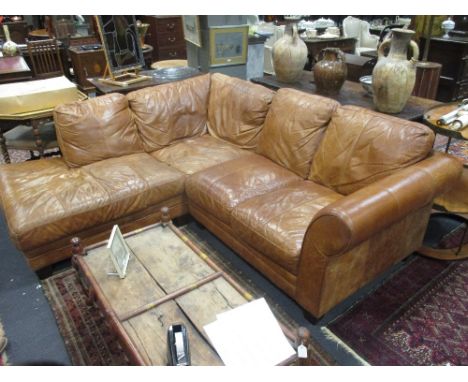 A contemporary caramel leather corner sofa, 230 x 200cm   Ink stains to leather and some scuffing from use.  The corner seat 