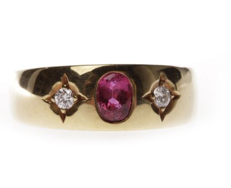 RUBY AND DIAMOND SET BANDof tapered form and with a central counter sunk oval created ruby flanked by two diamonds, size Q, 6