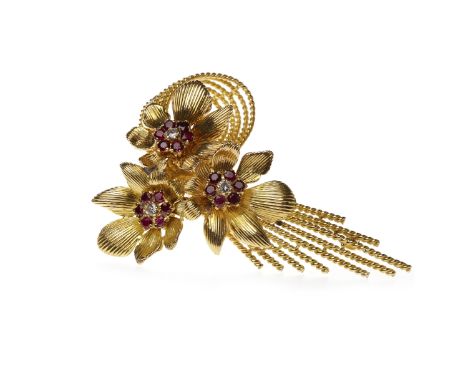 EIGHTEEN CARAT GOLD RUBY AND DIAMOND BROOCHin the form of a floral spray, set with round rubies and diamonds, 75mm long, 38g 