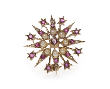 RUBY AND SPLIT PEARL BROOCHof star form, with round rubies and a central section of split pearls, 2.9cm in diameter, hallmark