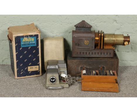 Two projectors and slides. To include a cased 1960s Aldis 303 slide projector and an early 1900s brass lens magic lantern in 
