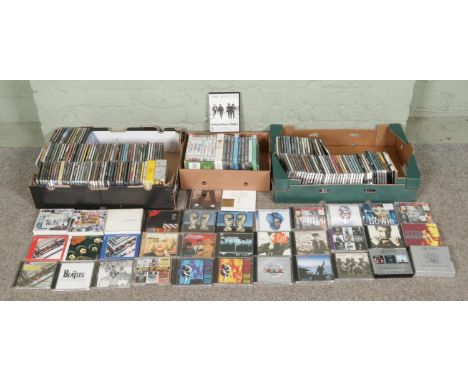 Three boxes of CDs and DVDs, including Beatles collection, Pink Floyd, David Bowie, Blondie, Queen, Guns N' Roses, Prince, Mi