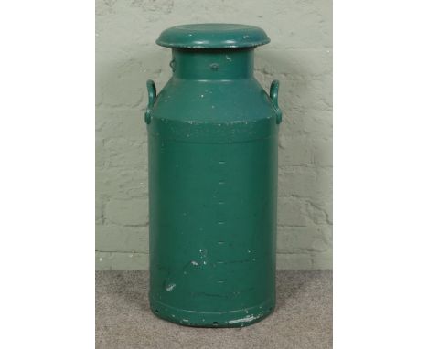 A large vintage Settle Creamery Ltd dairy milk churn with lid, green-painted with twin handles, width 33 cm, height 75 cm.