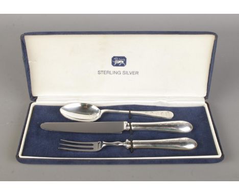 A cased three piece Christening set, consisting of silver spoon and silver handled knife and fork. Bearing assay marks for Sh