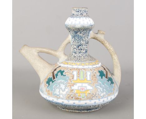 An Amphora Kendi style jug with stylized decoration. Height 19.5cm.