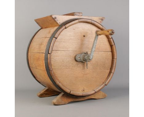 An oak coopered milk/butter churn, with winding handle. Produced by RA Lister, Dairy Engineers, Dursley. Height: 42cm.