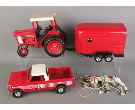 A group of vintage die-cast toys, including American ERTL International 886 tractor with horse trailer, ERTL Scout pickup tru