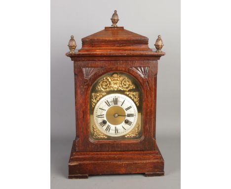A 19th century German mantel clock by Junghans, featuring three circular finials on the walnut case top, with an 8-day signed