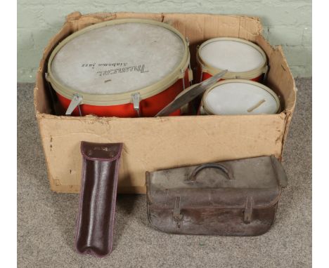 A box of musical instruments, including a drum set, vintage F. Besson cornet with case and Aulos recorder with bag.