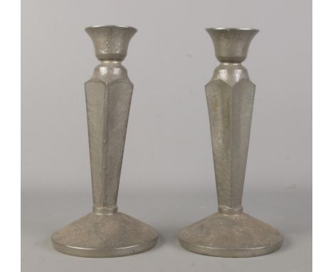 A pair of Tudric pewter candlesticks of square tapering form on rounded bases. Stamped DCM/Tudric 5088 to bases. Height 23cm.