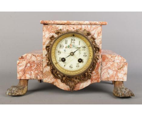 A Victorian French marble mantel clock by Fritz Marti, featuring gilt scrollwork framing the white enamel dial, with floral d