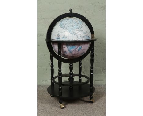 A Zoffoli globe drinks cabinet, with hinged top and under tray. Raised on castors. Height: 92cm.