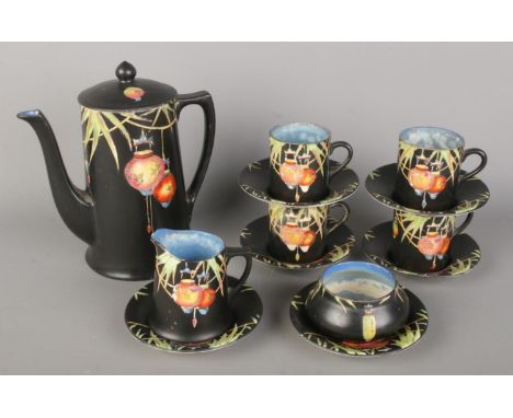A 1920s Crown Ducal "Chinese Lantern" pattern Art Deco coffee set, featuring a black background with coloured Chinese lantern