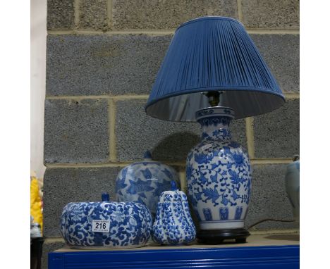 A collection of Chinese blue and white ceramics including table lamp and jars and covers.  (4)