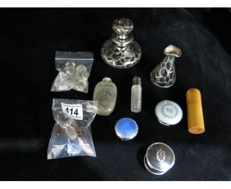 A collection of glass and silver scent bottle parts, including enamelled lids, stoppers and bodies, a Chinese reverse painted