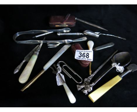 A collection of silver items including button hooks, Newcastle sugar tongs, cheroot holders, trowel book mark, toothpick etc