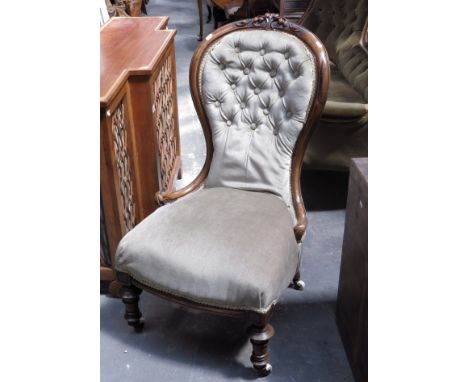 A mid-Victorian walnut spoonback chair, circa 1860, carved top rail, green velvet button upholstery, on ceramic castors.