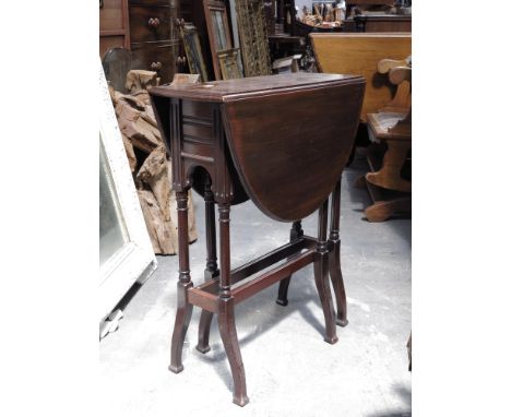 An Edwardian mahogany Sutherland table, on ring turned legs, 52cm wide.