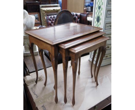 A 19th Century triple nest of mahogany tables, crossbanded and strung tops, ring turned legs, 73 by 48 by 31cm.