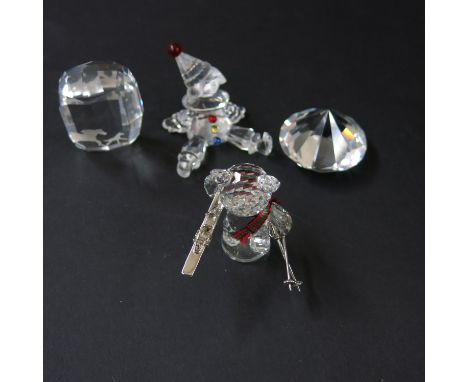 Swarovski crystal ornaments including a clown puppet clown, ski bear, wild horse monolith, and a single cut diamond  (4)
